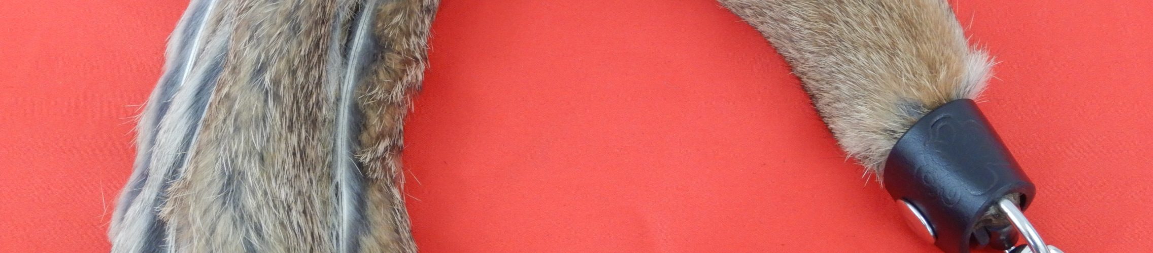 Luxurious rabbit fur flogger with soft leather finger loops attached by snap hook.